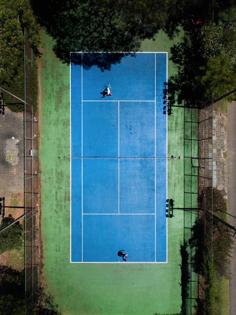 Two tennis players practicing together